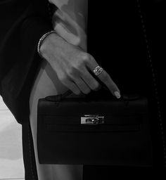 black and white photograph of a woman's hand holding a briefcase