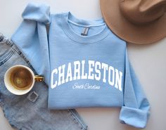 "Charleston Sweatshirt Fashionable fun designs printed on premium quality shirts for women, men and kids. With over 100+ tee shirts, workout and fitness tanks, birthday shirt, bachelorette party shirts, family vacation tees, cruise tees, custom t shirts, pet shirts and more being added weekly. We have something for everyone! We offer this sweatshirt in adult unisex/men's sizes ranging from S-XXL. Don't see what you want? Just ask! We might be able to make it for you. If you would like a differen Fitted Cotton Crew Neck Sweatshirt, Blue Tops With Letter Print And Comfortable Fit, Comfortable Blue Letter Print Top, Blue Letter Print Top With Comfortable Fit, Casual Fitted Letter Print Sweatshirt, Cotton Sublimation T-shirt With Letter Print And Relaxed Fit, Sporty Relaxed Fit Shirt For College, Fitted Cotton Collegiate T-shirt, Tri-blend Crew Neck Top For College