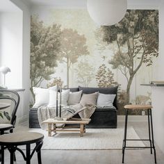 a living room with a couch, chair and wallpaper