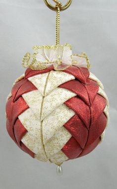 a red and white ornament hanging from a chain