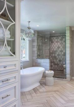 a white bath tub sitting inside of a bathroom next to a walk - in shower