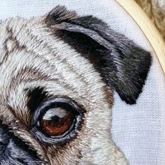 a close up of a pug's face in a cross stitch embroidery pattern