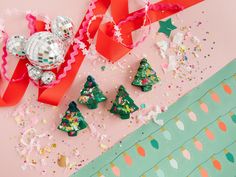 christmas decorations and confetti on a pink background