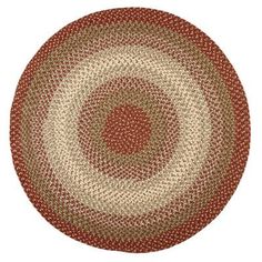 a round rug with red and beige circles on the center, in an oval shape