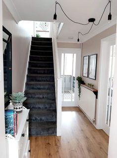 a staircase leading up to the second floor in a house with wood floors and white walls