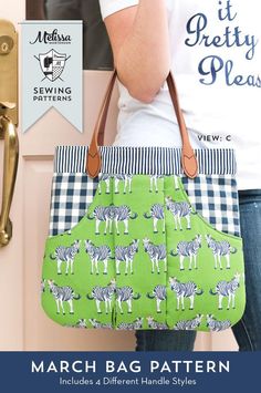 a woman holding a green and white bag with zebras on it, in front of a pink door