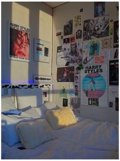 a bedroom with posters on the wall and bed