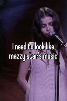 a woman singing into a microphone with the words i need to look like mazzy star's music