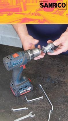 a man is working with tools on the table