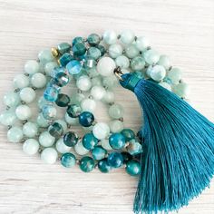 A gorgeous gemstone mala necklace featuring stunning blue apatite and green angelite gemstone beads.  Accented with 22k gold brushed spacer beads.  Hand strung and knotted with 100% silk thread and finished with a beautiful silk tassel. A mala of clarity, ambition and support.  Apatite assists in manifesting your goals with vigor while feeling supported with green angelite. Diy Tassel Necklace, Luxury Gifts For Her, Jewerly Making, Diy Tassel, Beading Jewelry