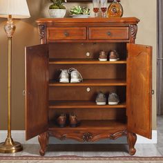 a wooden cabinet with shoes on it and a lamp