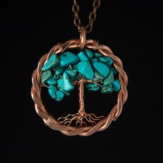 a tree of life pendant with turquoise stones