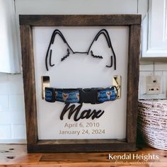 a wooden frame with a cat's head and glasses on it