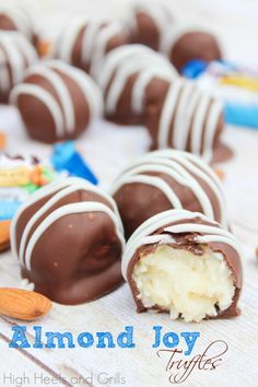 almond joy truffles on a white table with nuts and candy in the background