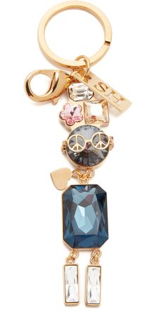 a gold key chain with charms on it and a blue crystal stone in the middle