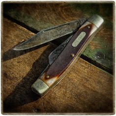 a knife sitting on top of a wooden table