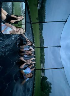 four girls are standing in the water with their arms around each other