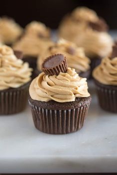 chocolate cupcakes with peanut butter frosting and oreo cookies on the top