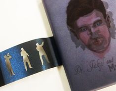 the book is opened to show an image of a man's face and three other people