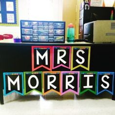 a desk with the words mrs morri's spelled out in bright colors on it