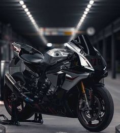 a motorcycle parked in a parking garage with its lights on and it's front wheel still attached to the bike