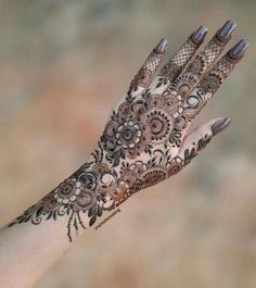 a woman's hand with hennap on it, showing the intricate design