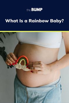 a pregnant woman is holding a toy in her belly with the words what is a rainbow baby?