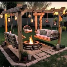 an outdoor fire pit with swings and seating