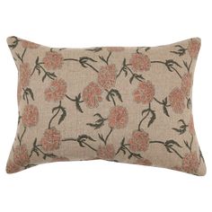 an orange and black floral pillow on a white background