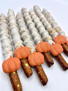 there are many candy sticks with pumpkins on them in the shape of candies