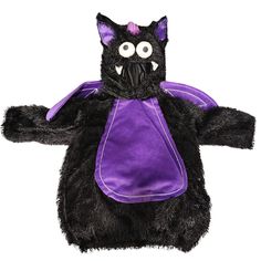 a black stuffed animal with purple clothing on it's chest and eyes, standing in front of a white background