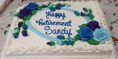 a white cake with blue and purple flowers on it that says happy retirement sandyy