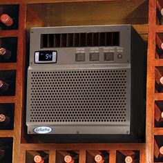 an old radio sitting on top of a wooden shelf filled with wine bottles and corks