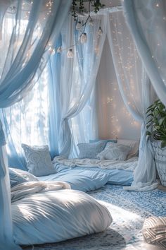 a canopy bed with white curtains and lights hanging from it's sides in a bedroom