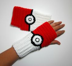 two crocheted red and white wrist warmers on someone's hand,