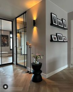 a living room filled with furniture and pictures on the wall