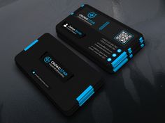 two black and blue business cards sitting on top of a table