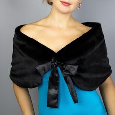 a woman in a blue dress with a black bow