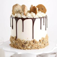 a cake with white frosting and cookies on top