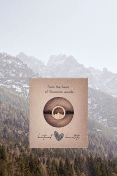 a poster with the words from the heart of stevens woods written on it in front of mountains and trees