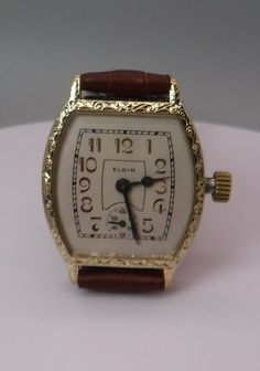 This beautiful Elgin watch looks just like it did when it came home from a Jewelry store in 1928.  The watch is simply amazing. This is an Elgin, 15 Jewel, Art Deco Style Wristwatch, circa. 1928.  This watch has an Elgin 3/0s size, circa. 1928, Grade 464, model 2, 15 Jewel movement.  This is one of the finest wristwatch size movements Elgin made at that time and has a very precise screw adjustment regulator for very fine regulating of the balance spring.   The watch has a perfect white linen col Luxury Chronometer Watch For Collectors, Art Deco Formal Rectangular Watch, Formal Art Deco Rectangular Watch, Vintage Rectangular Chronometer Watch, Classic Watches With Rectangular Dial For Collectors, Classic Collectible Watch With Rectangular Dial, Antique Chronometer Watch With Rectangular Dial, Antique Watches With Chronometer And Rectangular Dial, Antique Watch With Chronometer And Rectangular Dial