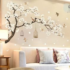 the living room is decorated with white flowers and birds