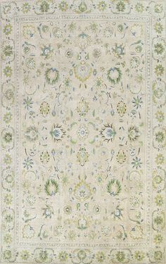 an antique rug with many different colors and designs on the carpet, including blue, green, yellow, and white