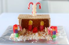 a small gingerbread house with candy and candies