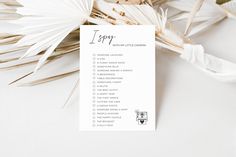 a list with palm leaves next to it on top of a white table cloth and some other items