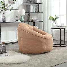 a living room filled with furniture and a white rug on top of a hard wood floor