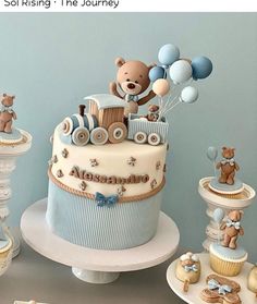 a baby shower cake with teddy bears and balloons