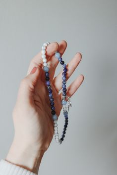 This beautiful gemstone rosary bracelet features Blue Angelite beads as the paters with a combination of Sodalite beads and white howlight beads beads as the aves. Each of our stretch and wrap rosary bracelets is a full rosary. 

Each bracelet also includes a “bookmark”crucifix medal. This medal is moveable and can help you keep track of where you are at in your rosary as you pray throughout your day.

Each bracelet is strung on durable elastic making it easy to stretch and wrap around your wrist without fear of snapping it. Adjustable Rosary Bracelet For Healing With 108 Beads, White 8mm Beads Rosary For Meditation, White Rosary With 8mm Beads For Meditation, Hand Wrapped Rosary Bracelet With Round Beads For Healing, Hand Wrapped Rosary Bracelet For Healing, Adjustable Natural Stones Rosary For Meditation, Adjustable Hand-strung Healing Rosary, Healing Rosary Bracelet With Natural Stones, White Beaded Rosary Bracelet For Healing