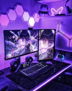 two computer monitors sitting next to each other on top of a desk in front of purple lights