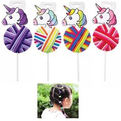 four different colored lollipops with unicorn heads on them